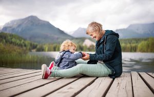 grandma-and-granddaughter-sitting-lakeside