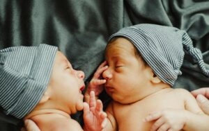 twin infants facing each other